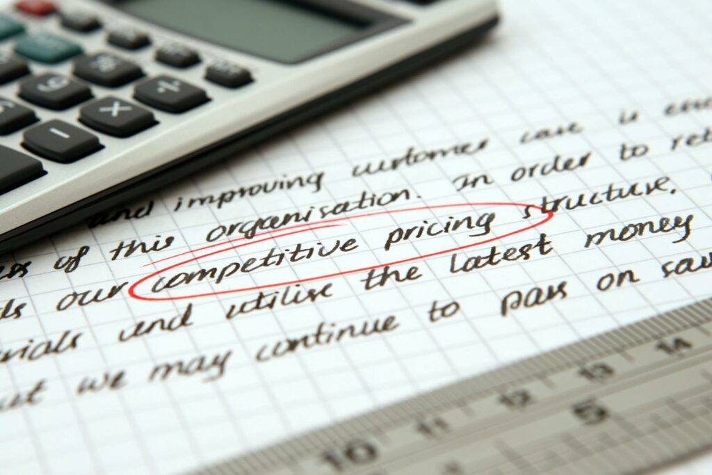 The importance of business budgets, forecasts, and goals - Competitive Pricing Handwritten Text Encircled on Paper