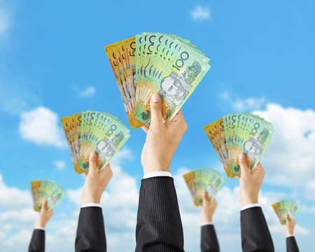 Crowdfunding - hands holding Australian dollar banknotes