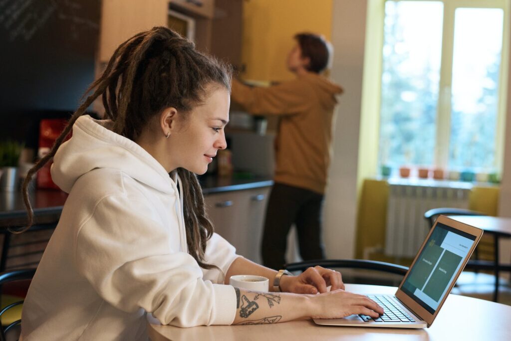 The benefits of outsourcing for small business - Shallow Focus Photo of Woman Using a Laptop