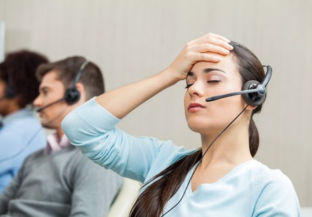 Undesirable customer types - tired female customer service agent in call centre