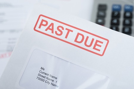 Managing debtors - extreme close-up of past due bill envelope