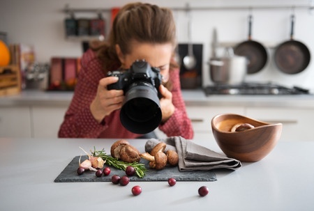 A woman photographing fruit and vegetables for her blog