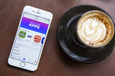 Smart phone displaying the word "Apps" and cappuccino cup.