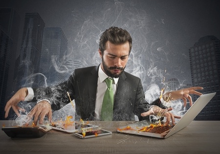 Avoid business owner stress - a frantic businessman steams as he works on multiple tasks