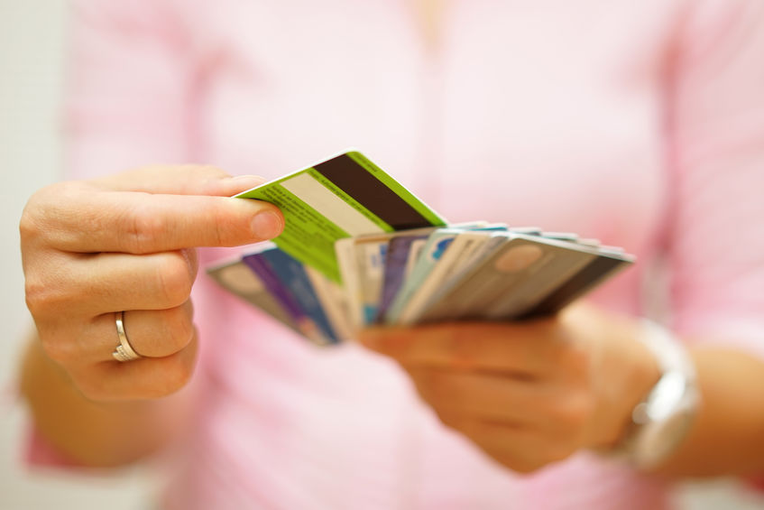 Tips for choosing a business credit card - woman choosing one credit card from many