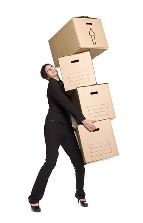 Woman carrying stack of boxes