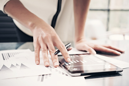 6 Essential accounting terms - a woman reading financial reports with tablet