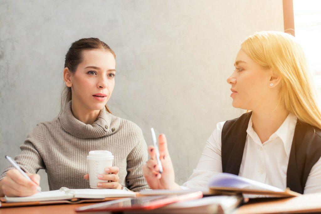 What is a fractional CFO? - Two Women Holding Pen