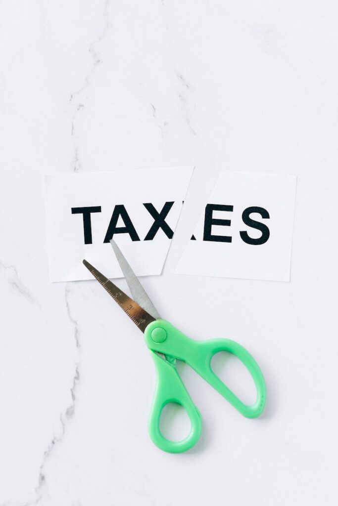 Business Update – 1 February 2024 - Taxes cut with Green Handle Scissors on White Surface