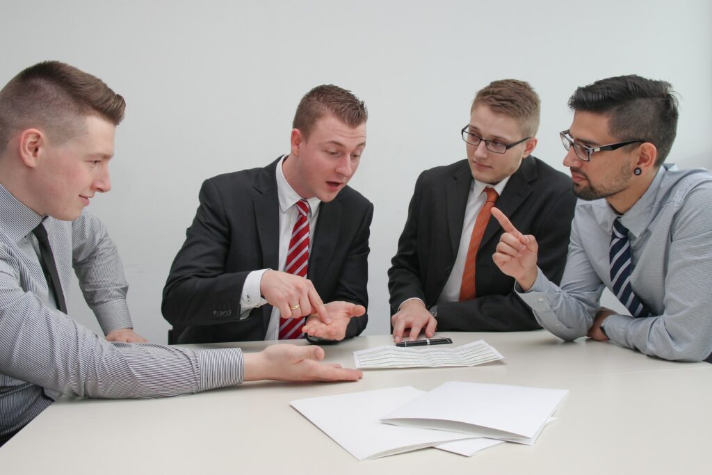 What to do in a business partnership break-up - four men sitting at desk talking