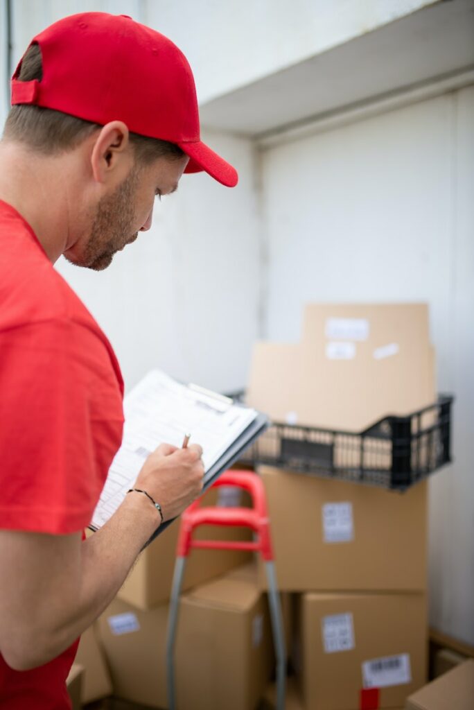 Mastering the Art of Lean Inventory and Just-In-Time Management - Man in Red T-shirt Holding clipboard