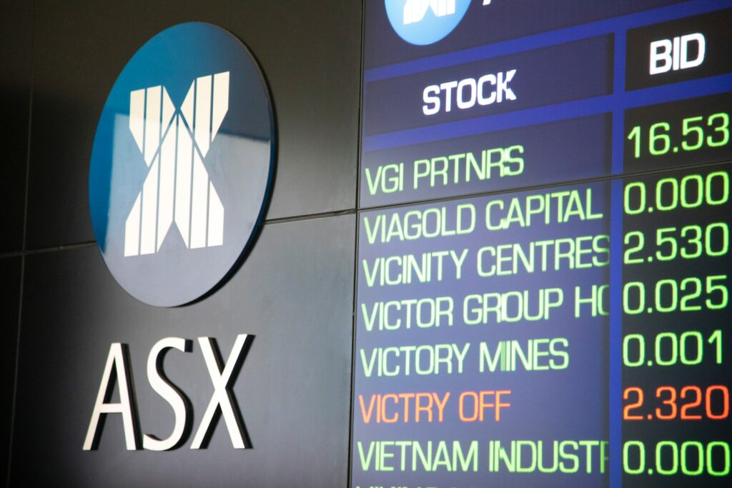 Business Update – 18 May 2023 -ASX logo on a wall beside a display of company data