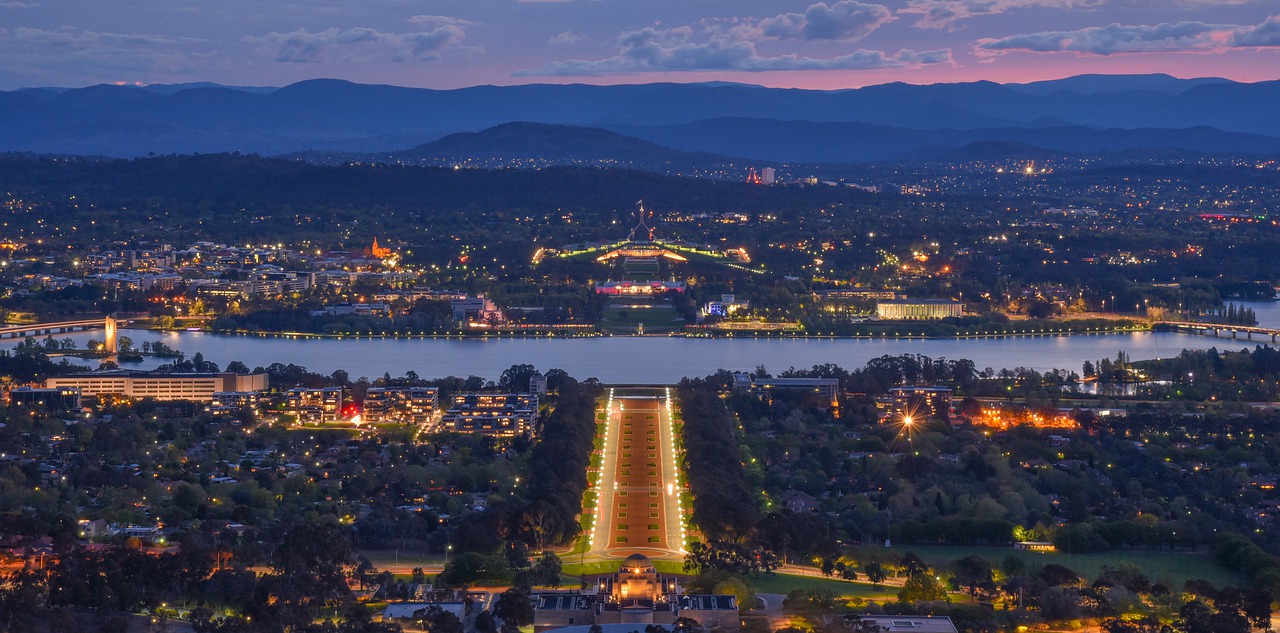 Federal Budget 2022: What it means for you - a view of Anzac Parade and the parliament house at twilight