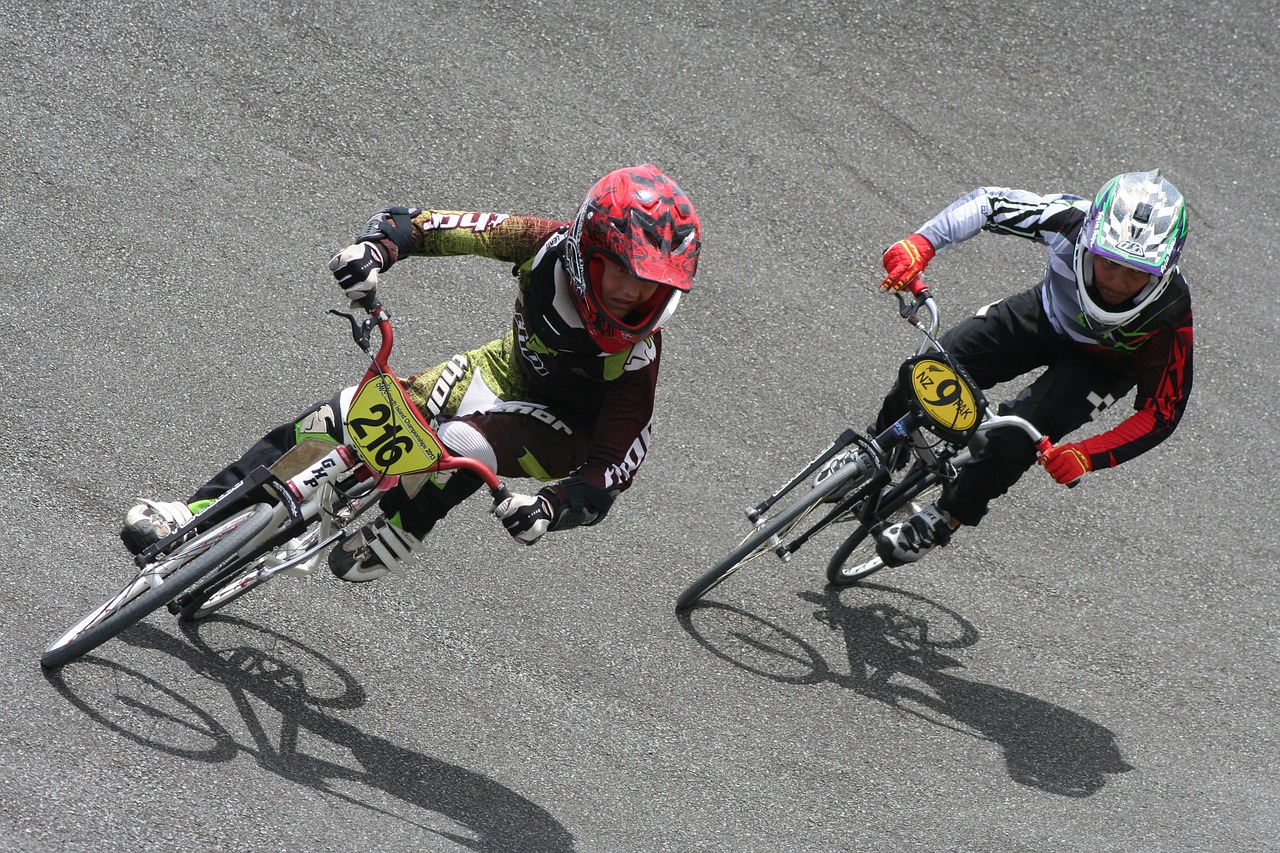4 ways a small start up can take on established competitors - a cyclist in a race catches up with the leader