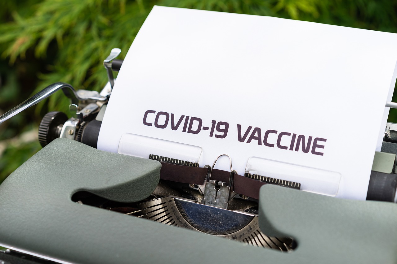 COVID-19 Business Update - 10 September 2020 - the words "COVID-19 Vaccine" on a page in a manual typewriter