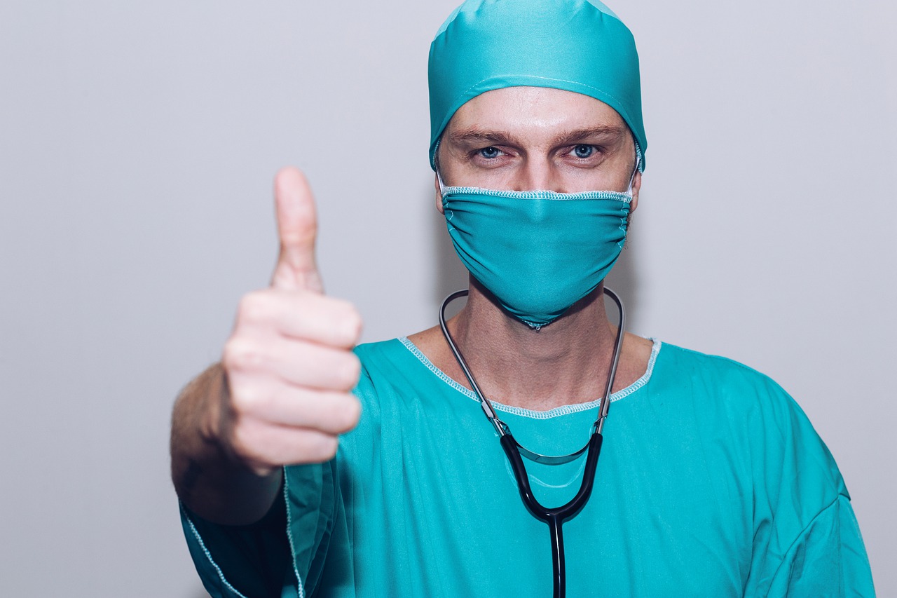 COVID-19 Business Update – 11 February 2021 - A doctor with mask and stethascope gives a thumbs-up gesture.