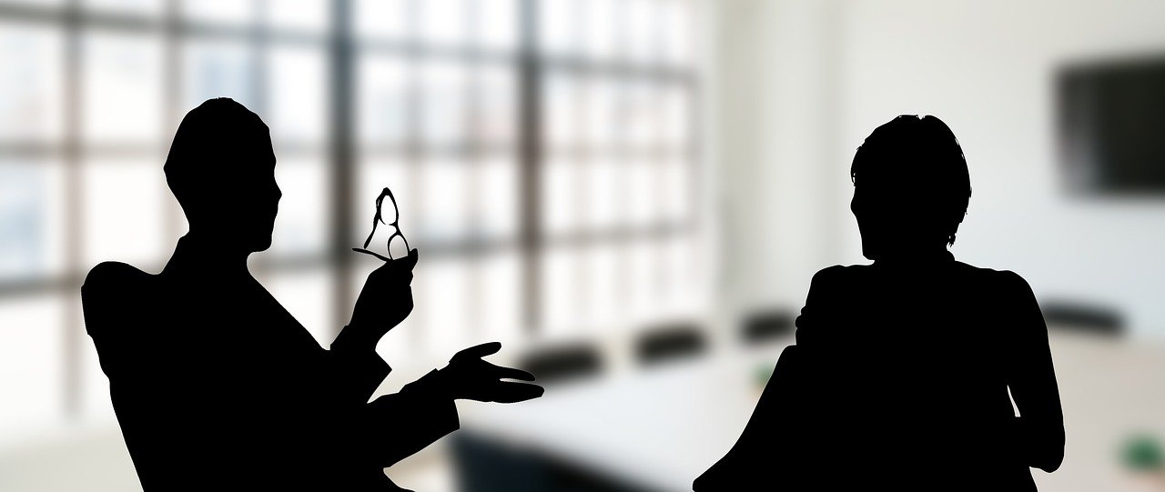 Sometimes we have to say No - two business people in silhouette having a discussion.