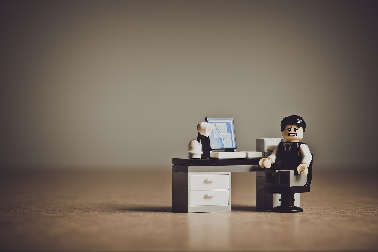 What's new in 2022-2023 - A LEGO businessman at a desk with a stressed-out expression