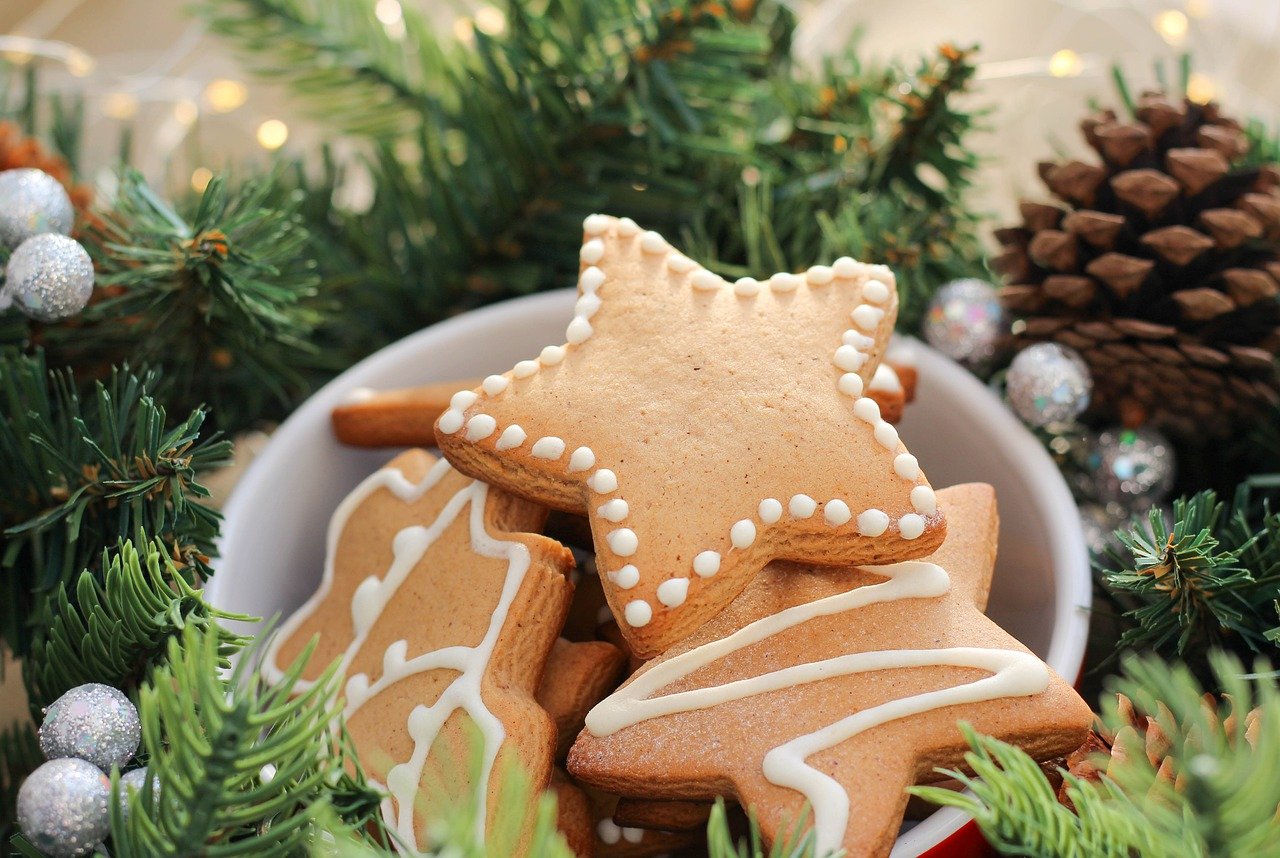 May you have a happy and relaxing holiday period - a bowl of gingerbread cookies surrounded by greenery
