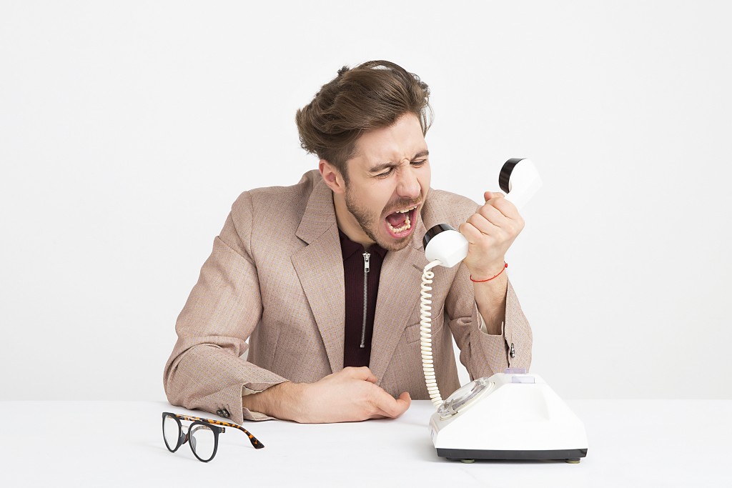 Three terrible management habits - man screaming into telephone receiver