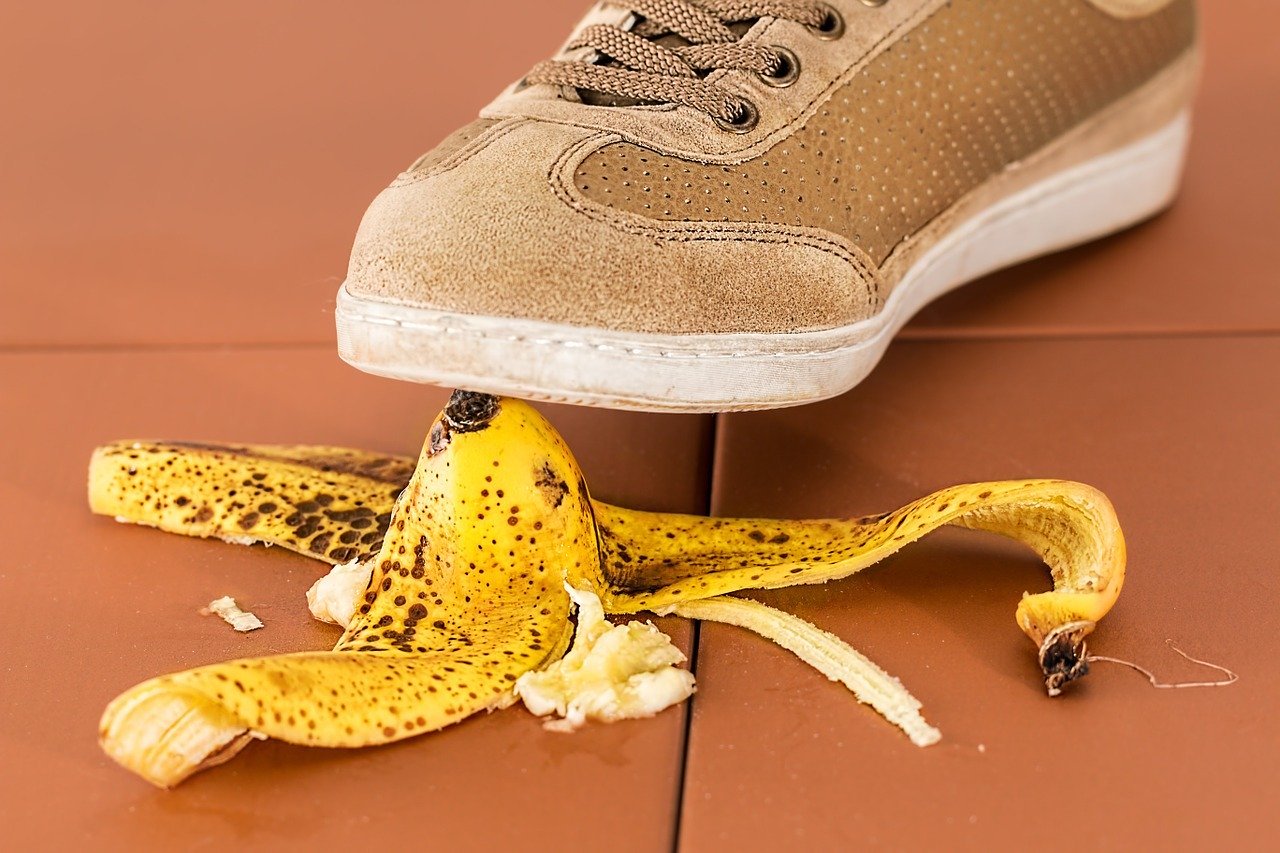 Three reasons why you need small business insurance - a foot about to step on a banana peel