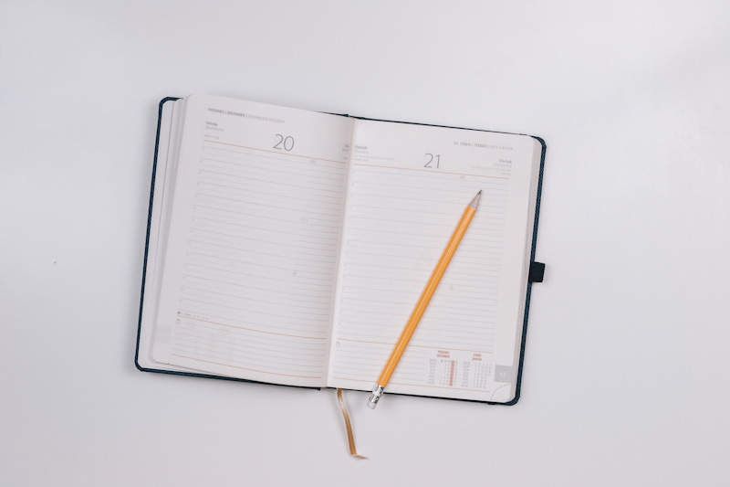 Save time with appointment booking apps - photo of traditional appointment book and pencil.