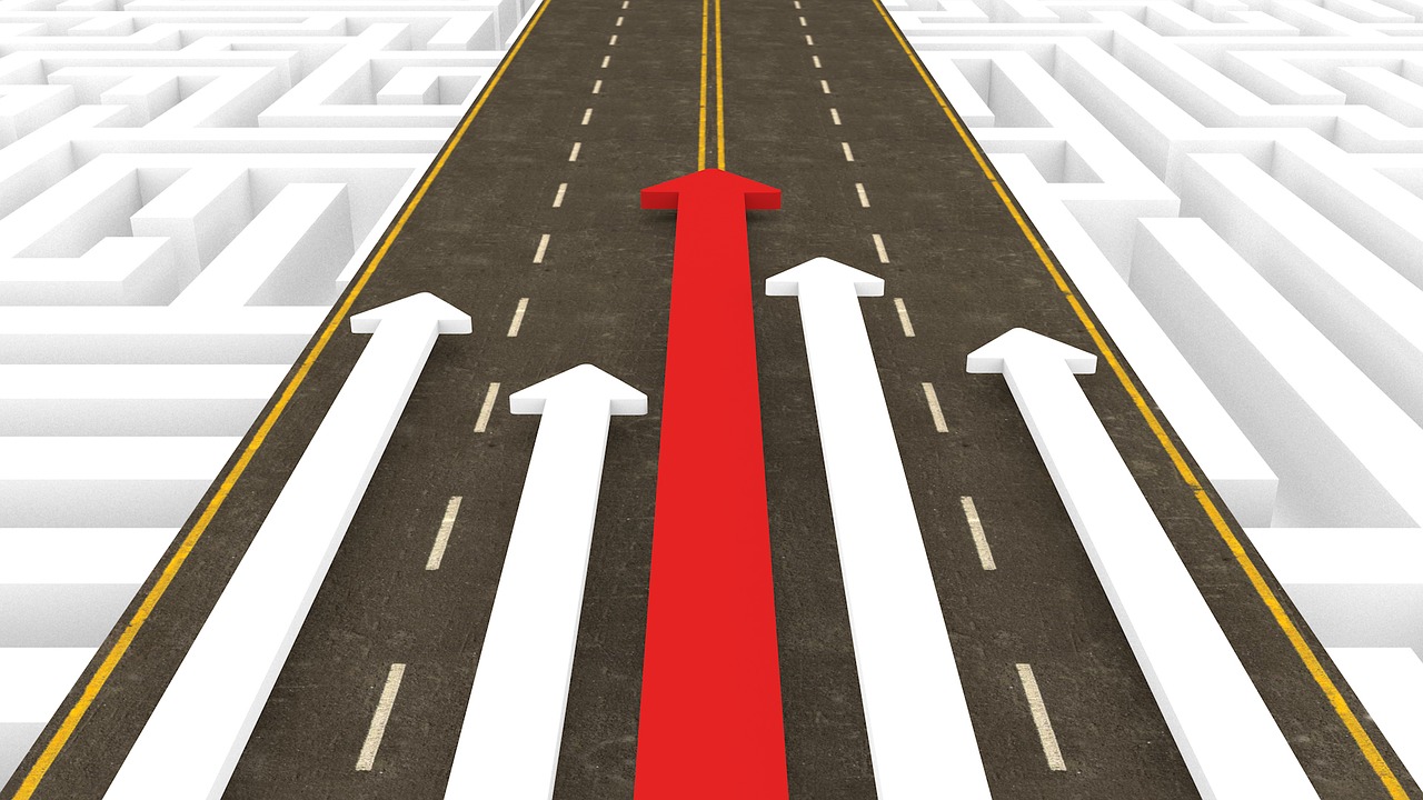 4 Tips to position yourself as a market leader - A red arrow pulls ahead of white arrows on a highway.
