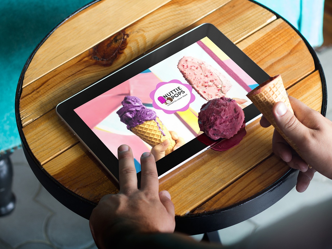 Five Simple Marketing and Promotion Tips to help during COVID-19 - A tablet user drops their ice cream onto a digital advertisement for the ice cream
