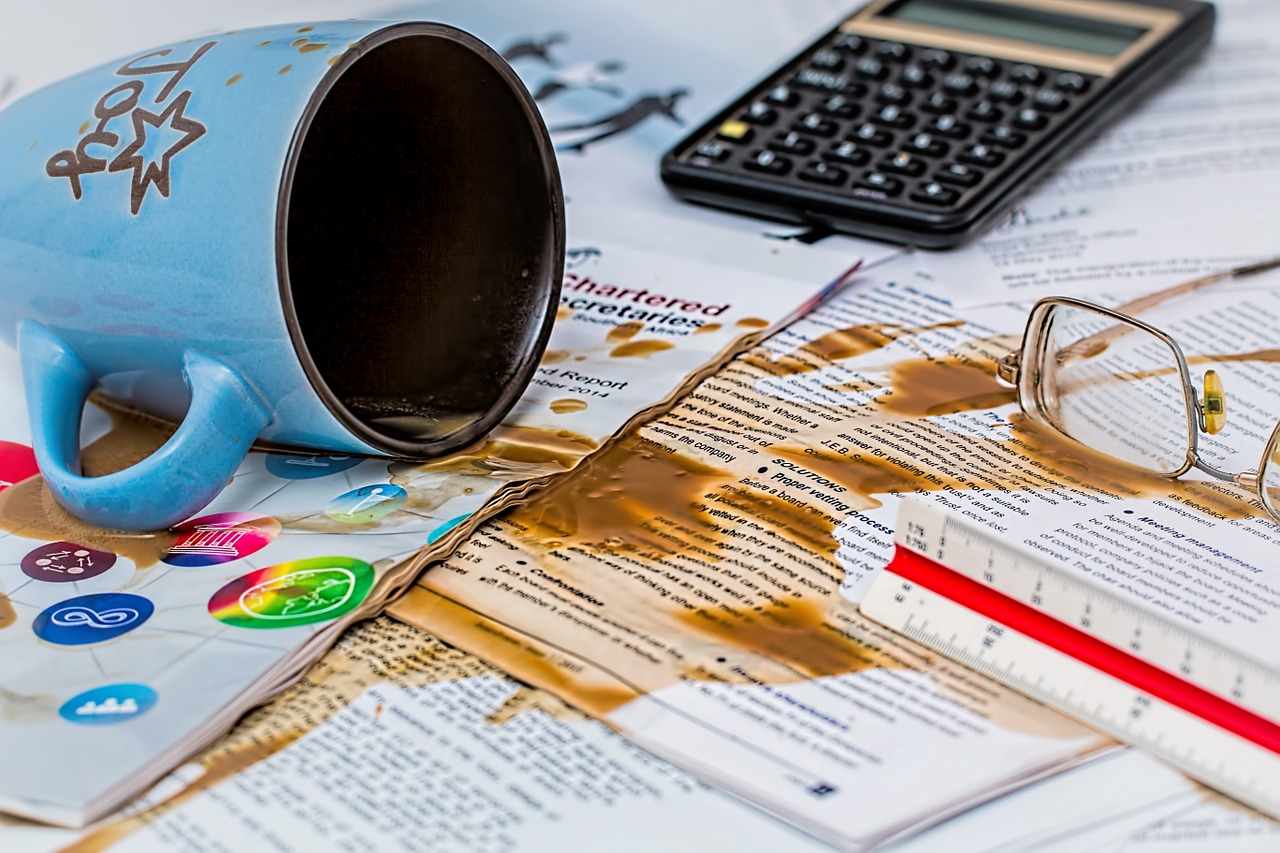 5 Most Common Accounting Mistakes That Could Hurt Your Business - a cup of coffee spilt all over accounting records