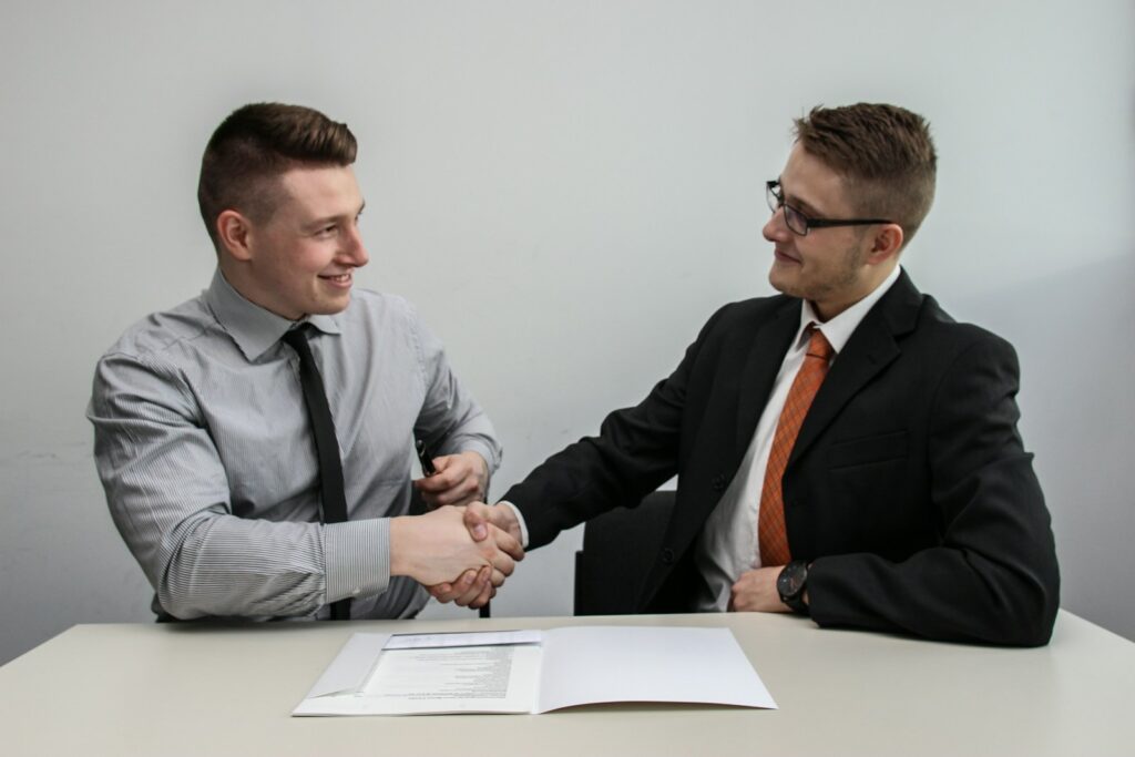 5 key steps to prepare to successfully sell your business - two men shaking hands over a contract
