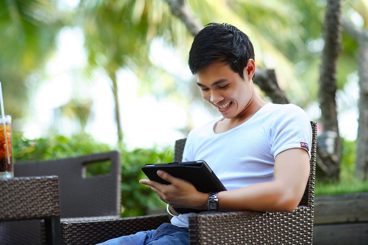 3 Ways to Delight Your Online Customers - a delighted customer looking at his tablet computer.