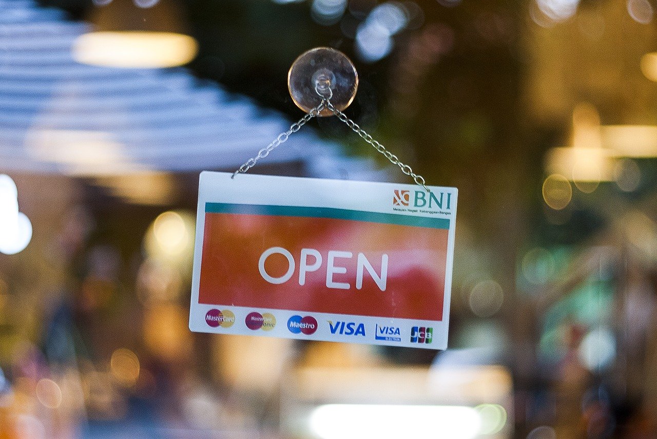 What to do when reopening your business - an open sign on a business window