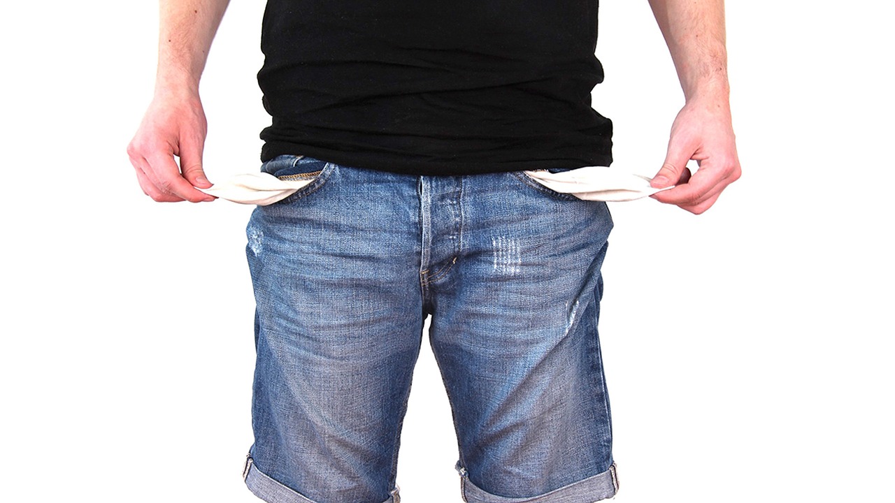 5 Personal finance hacks to start now - a man pulls out his pockets to show that he has no money.