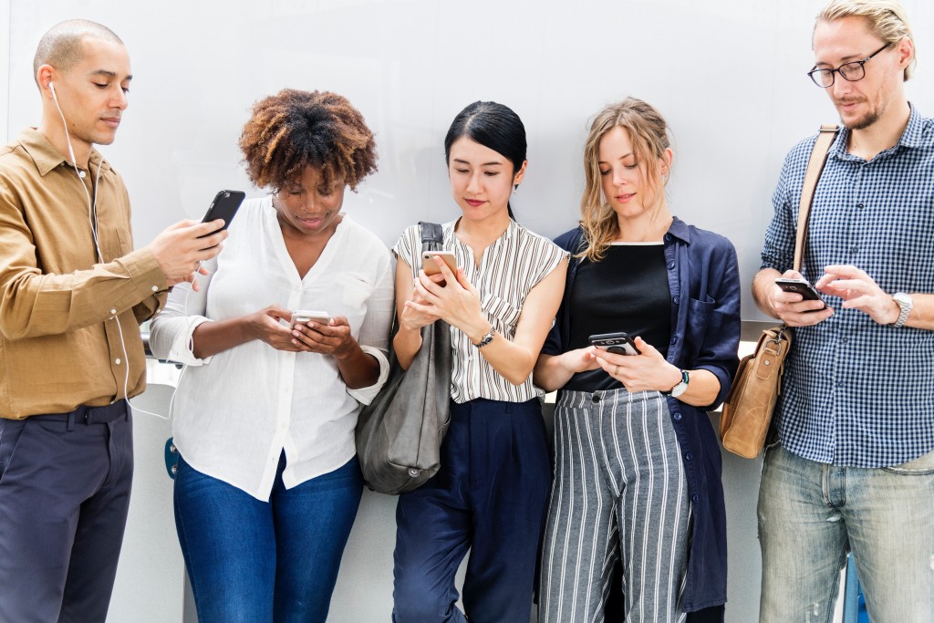 Boosting social proof - photo of a group of people looking at their phones