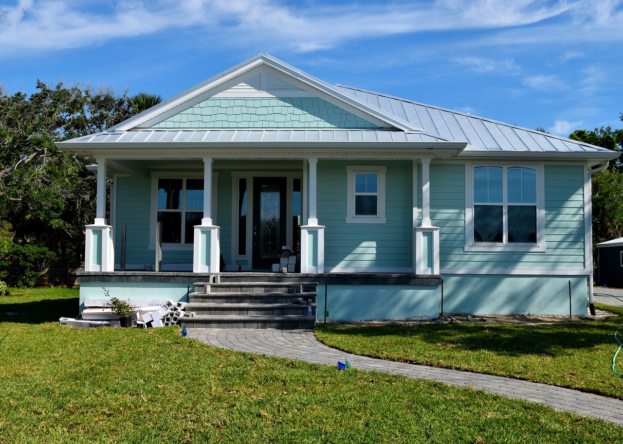 Tips for buying your first investment property - a pale blue weatherboard house