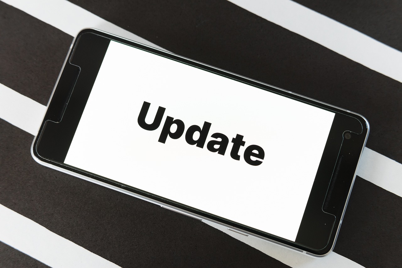 COVID-19 Business Update - 1 July 2020 - the word "Update" on the screen of a smartphone